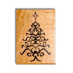 May include: A wooden stamp with a black and white design of a stylized Christmas tree. The tree has a star on top and is made up of swirls and curves.