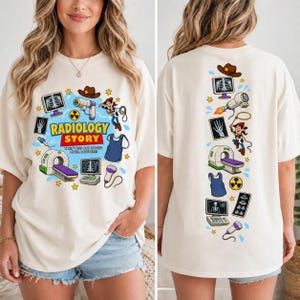May include: An off-white t-shirt featuring a graphic print with the text RADIOLOGY STORY. The design includes illustrations of a cowboy character, a CT scanner, X-ray monitors, a lead apron, a radiation symbol, and medical imaging equipment.