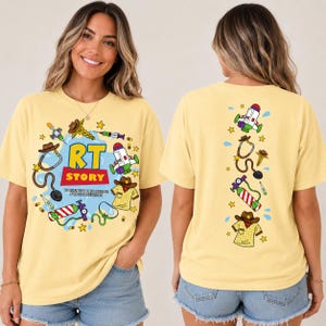 May include: A pale yellow t-shirt featuring a graphic print. The front displays the text RT STORY with medical and space-themed icons like a stethoscope, oxygen tank, and cowboy hat. The back shows a vertical arrangement of these same icons.