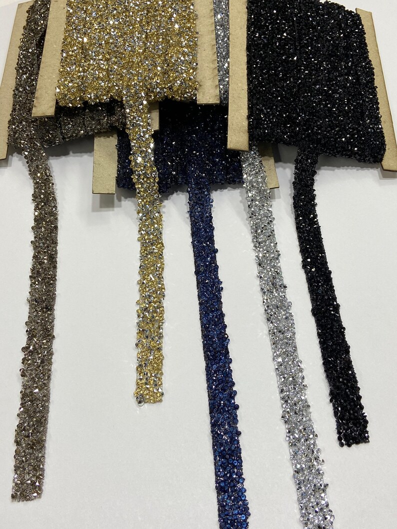 May include: Assortment of six different colored beaded trims. The trims are made of small, sparkly beads in silver, gold, black, navy blue, and light blue.