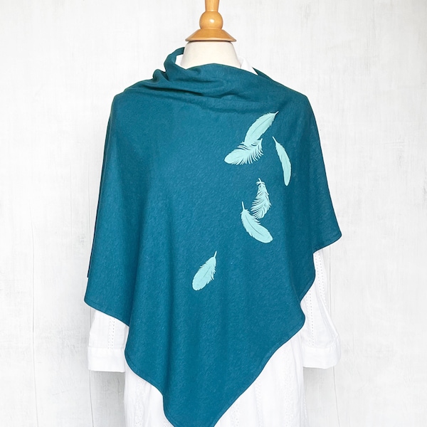 May include: Teal blue poncho with a white background and a design of light blue feathers.