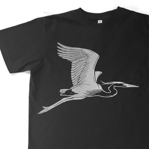 May include: A black t-shirt with a white silhouette of a heron in flight.