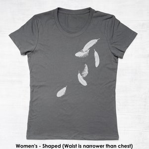 May include: A charcoal gray t-shirt with a design of white feathers falling on the right side of the shirt.
