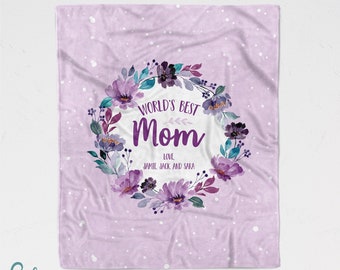 May include: Purple and blue floral wreath with the text "World's Best Mom" and the names "Jamie, Jack, and Sara" on a light purple background with white polka dots.