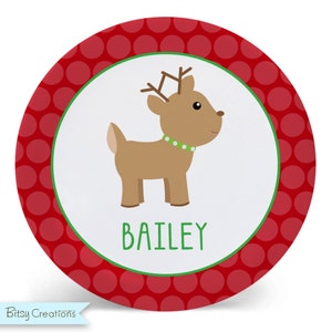 May include: A red and white personalized Christmas plate with a reindeer illustration and the name "BAILEY" in green text.