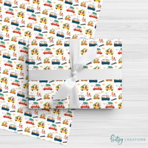 May include: White wrapping paper with a repeating pattern of colorful cars, reindeer, and Christmas trees. The word "GABRIEL" is printed on the design. A wrapped gift with a white ribbon is on top of the paper.