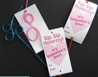 May include: Three Valentine's Day gift tags with pink hearts and the text "Sip, Sip. Hooray! It's Valentine's Day!" Each tag has a hole punched at the top and a straw threaded through it.