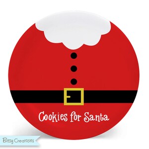 May include: Red and white Santa Claus plate with black buttons and a black belt with a gold buckle. The plate says "Cookies for Santa".