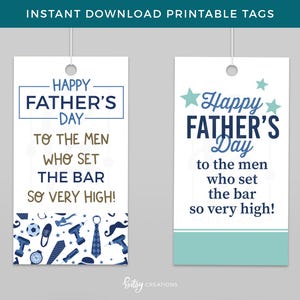 May include: Two rectangular Father's Day gift tags with the text "Happy Father's Day" in blue and white. The tags include the message "To the men who set the bar so very high!" and decorative elements.