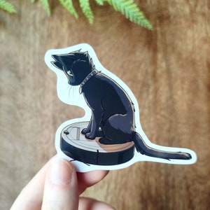 Chat noir dans le Roomba - Sticker vinyle brillant, imperméable