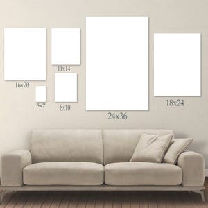 May include: A collection of blank white canvas art prints in various sizes, including 5x7, 8x10, 11x14, 16x20, 18x24, and 24x36 inches. The prints are displayed above a beige sofa against a neutral wall.