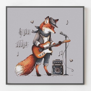 May include: Framed illustration of a fox playing an electric guitar. The fox is wearing a hat, scarf, and jacket. Musical notes and hearts surround the fox. An amplifier and microphone are also present. The colour palette includes orange, grey, and brown.