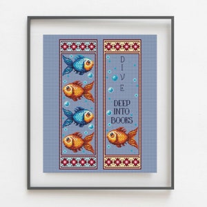 May include: Two cross-stitch bookmark patterns featuring a blue and orange fish design. The text on the right bookmark reads "Dive Deep Into Books".