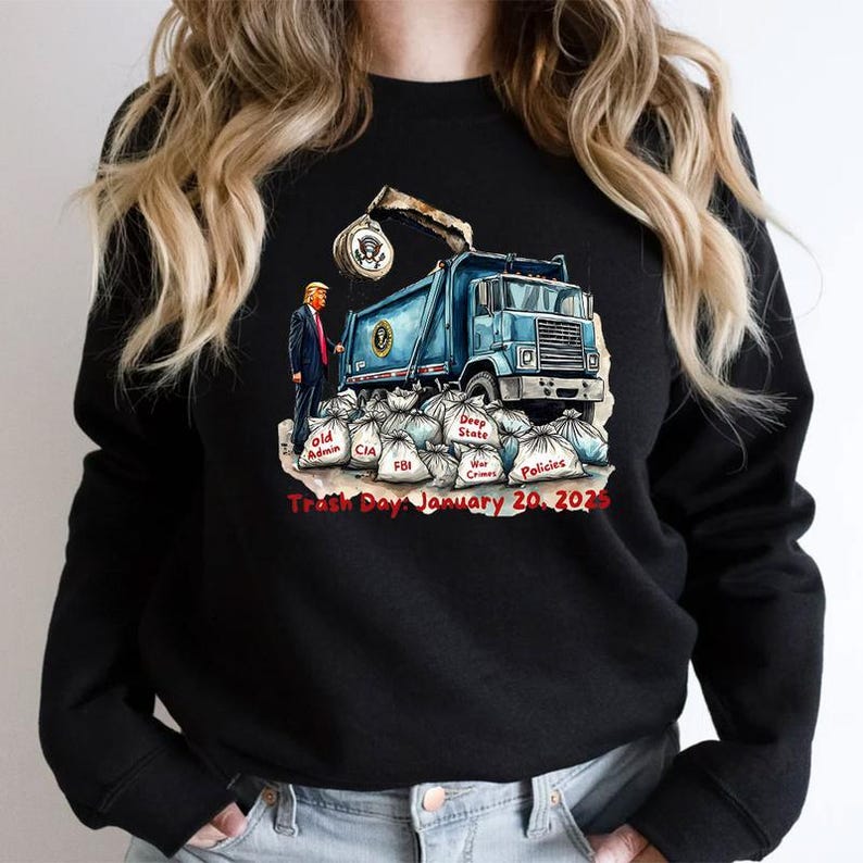 a woman wearing a black sweatshirt with a blue dump truck on it