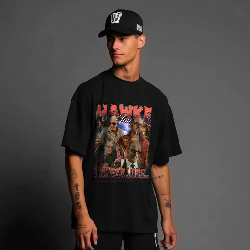 a man wearing a black hat and a black t - shirt