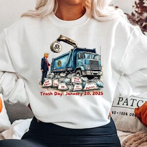 a woman wearing a sweatshirt with a picture of a dump truck