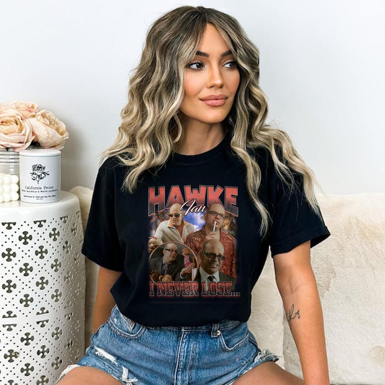a woman sitting on a couch wearing a black shirt