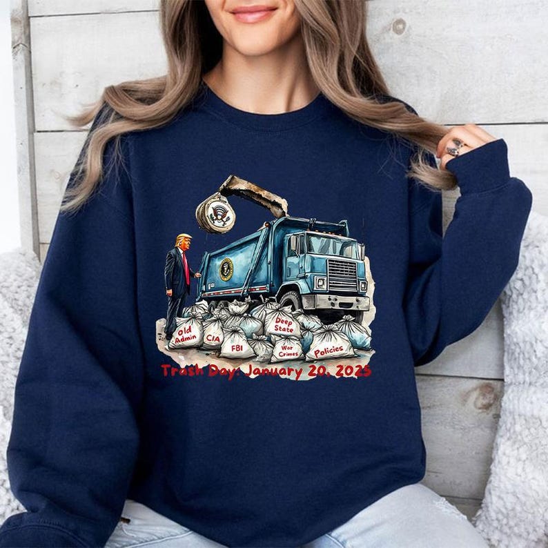 a woman wearing a blue sweatshirt with a dump truck on it