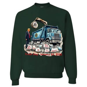 a green sweater with a picture of a man standing next to a dump truck