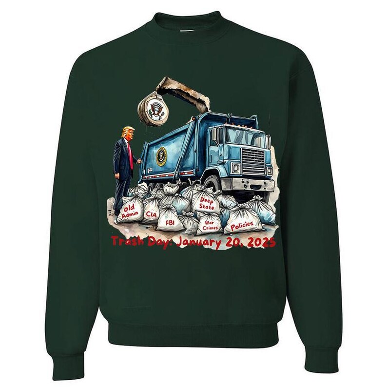 a green sweater with a picture of a man standing next to a dump truck
