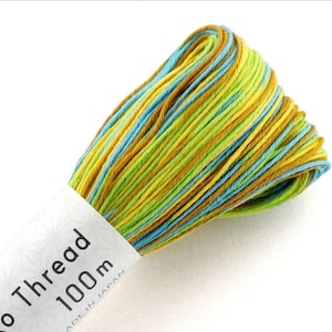 May include: A skein of green, yellow and blue embroidery floss with a label that reads "Ko Thread 100m Made in Japan."