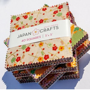 May include: A stack of 40 fabric squares with a floral pattern in shades of red, yellow, green, and purple. The squares are 5 inches by 5 inches and are labelled "JAPAN CRAFTS 40 SQUARES | 5 x 5".