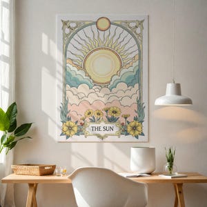 May include: A vintage-style tarot card illustration of The Sun. The card features a yellow sun with rays, clouds in shades of blue and pink, and yellow flowers. The text "THE SUN" is written in a decorative font at the bottom of the card.