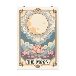 May include: A vintage-style tarot card illustration featuring a full moon with a radiating glow, surrounded by clouds. The card is titled "THE MOON" and features three pink lotus flowers.