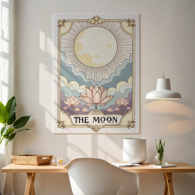May include: A vintage-style tarot card illustration featuring a full moon with rays of light, surrounded by clouds and pink lotus flowers. The card is titled "THE MOON".