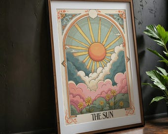 May include: A framed illustration of a sun with rays shining through clouds. The sun is orange and yellow, the clouds are pink, blue, and white. The illustration is surrounded by a decorative border and the text "THE SUN" is at the bottom.