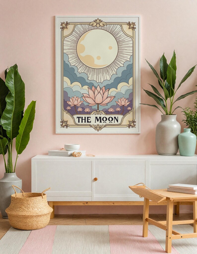 May include: A vintage-style tarot card print featuring the Moon card. The card depicts a full moon with rays of light, clouds, and lotus flowers. The text "THE MOON" is written in a decorative font at the bottom of the card.