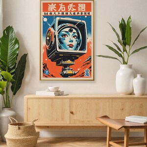 May include: A framed vintage-style poster with a retro sci-fi theme. The artwork features a woman's face inside a futuristic helmet, set against a red and blue background with Japanese text. The poster is displayed on a wooden cabinet.