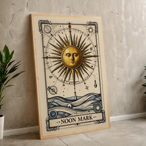 May include: Framed art print featuring a golden sun with a face at the center, surrounded by a compass design. Below, blue waves and a lighthouse are depicted. The text "NOON MARK" is displayed at the bottom.