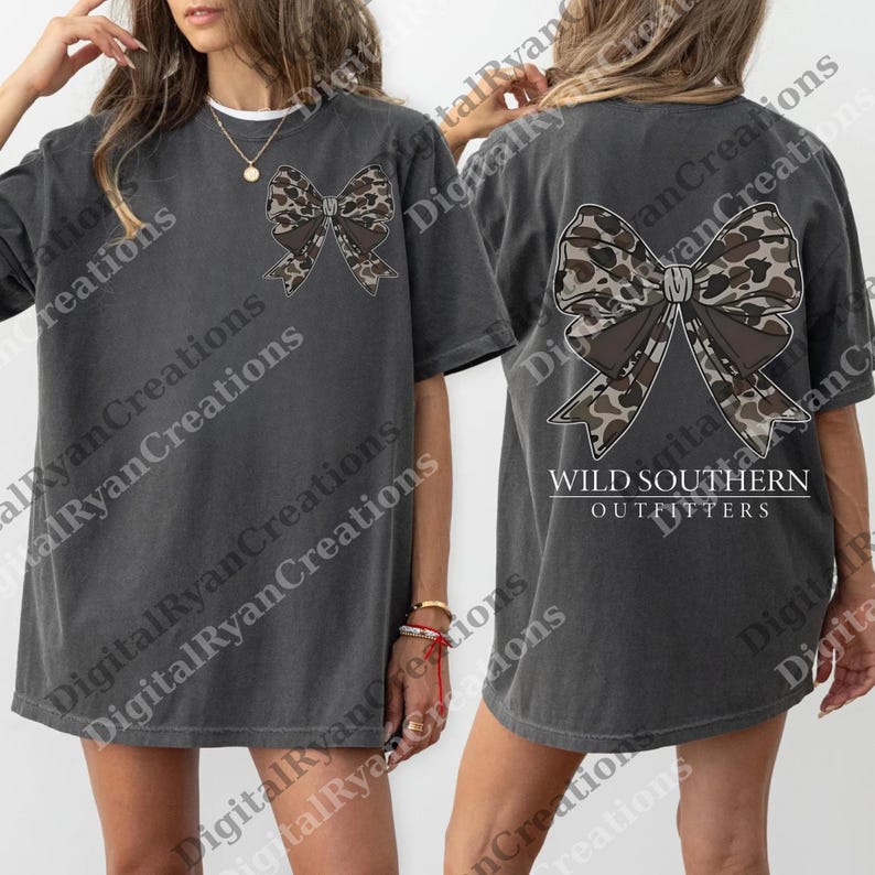 A woman wearing a gray t-shirt with a large bow on the front and the text "WILD SOUTHERN OUTFITTERS" printed on the back.