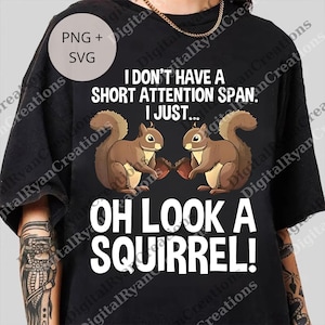 May include: Black t-shirt featuring the phrase "I don't have a short attention span. I just... Oh look a squirrel!" with two squirrel illustrations. The shirt also has a "PNG + SVG" graphic.