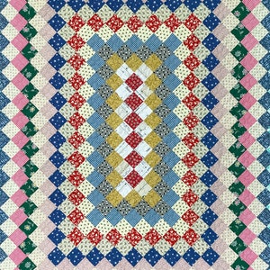 May include: A colorful quilt with a diamond pattern. The quilt features a variety of fabrics in shades of pink, green, blue, red, and yellow. The design is symmetrical, with a central rectangular pattern surrounded by borders.