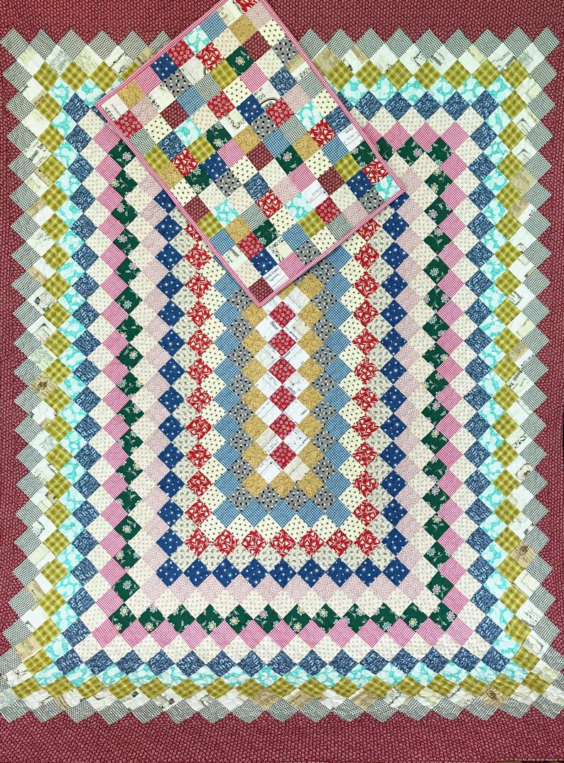 May include: A patchwork quilt and pillow set with a diamond pattern. The quilt features squares of various colors, including red, blue, pink, and green. The border is a solid maroon color. The pillow is a smaller version of the quilt.