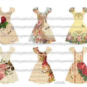 May include: Five vintage-style paper doll dress cutouts with floral and text patterns. The dresses are in shades of cream, yellow, blue, and pink with accents of red, green, and brown. The dresses feature floral designs, text, and dragonfly accents.