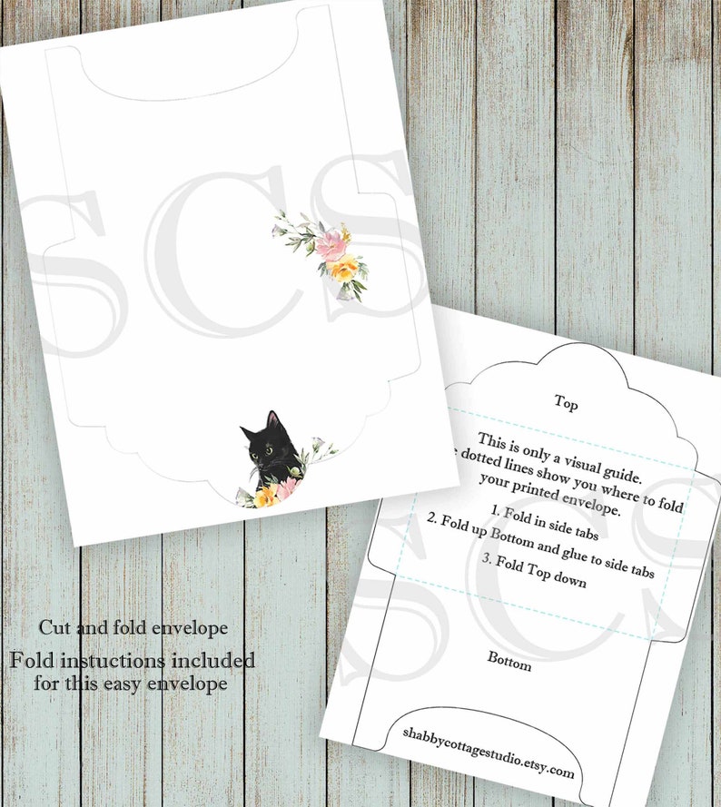 May include: Printable DIY envelope template featuring a black cat with floral accents. Instructions for folding and gluing the envelope are included. The text "This is only a visual guide. Dotted lines show you where to fold your printed envelope." is included.
