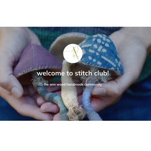Könnte beinhalten: Die Hände einer Person halten drei handgefertigte Stoffpilze. Die Pilze sind in den Farben Lila, Blau und Beige gehalten. Die Pilze sind mit Nähten und Mustern verziert. Der Text "welcome to stitch club! the ann wood handmade community" ist unter den Pilzen zu sehen.