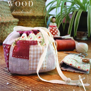 May include: A patchwork pouch with a drawstring closure, featuring a mix of patterned fabrics in red, beige, and floral prints. The text "ANN WOOD handmade" and "patchwork pouch a sewing pattern" are visible. A small floral pouch and sewing supplies are also present.
