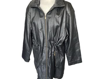 May include: Black leather jacket with a zip-up front, a collared neckline, and a drawstring waist. The jacket is displayed on a white mannequin and has a gold-colored zipper.