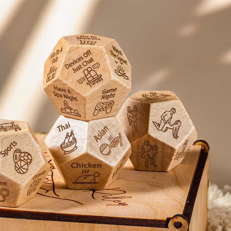 a bunch of wooden dices sitting on top of a wooden box