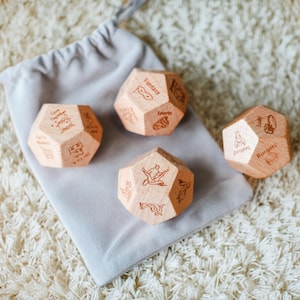 three wooden dices sitting on top of a white rug