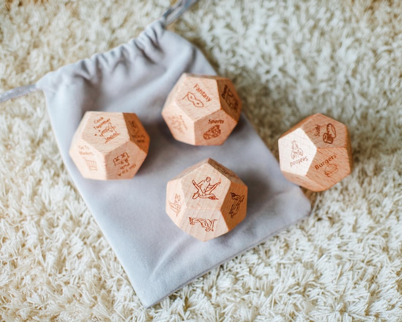 three wooden dices sitting on top of a white rug