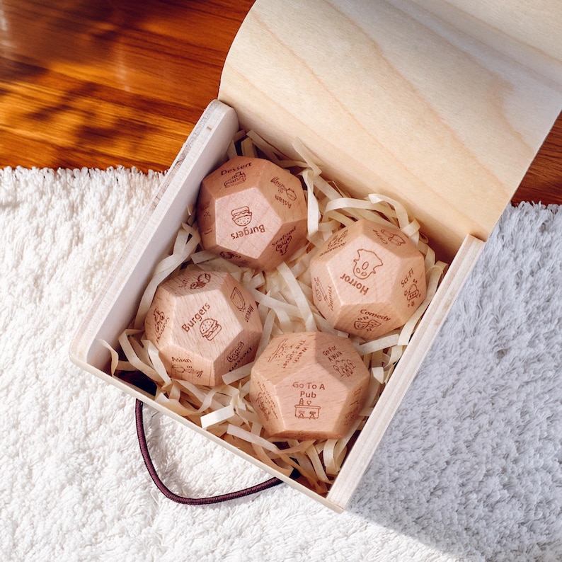 a box of wooden dices sitting on a rug