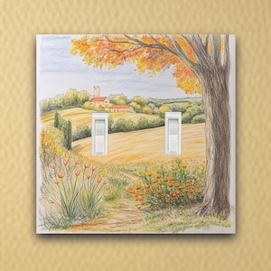 May include: A double light switch cover with a watercolor painting of a rural landscape. The scene features a small village with a church, a tree, and a field of flowers.