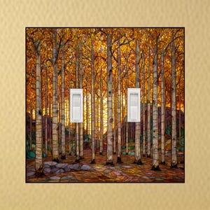 May include: A decorative light switch cover featuring a vibrant autumn forest scene. The artwork depicts tall, slender trees with golden leaves, set against a warm, glowing sunset. Two white light switch toggles are visible.