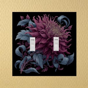 May include: A decorative light switch cover featuring a large, stylized flower in shades of purple and pink against a black background. The design includes blue-grey leaves and two white light switches. The cover is square.