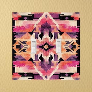 May include: A light switch cover with a geometric pattern in shades of pink, orange, purple, and black. The pattern is reminiscent of Native American art.